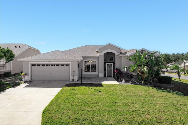 view of front of property featuring a front lawn and a garage