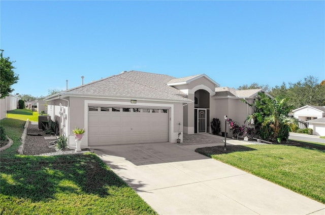 view of front of home with a front yard and a garage