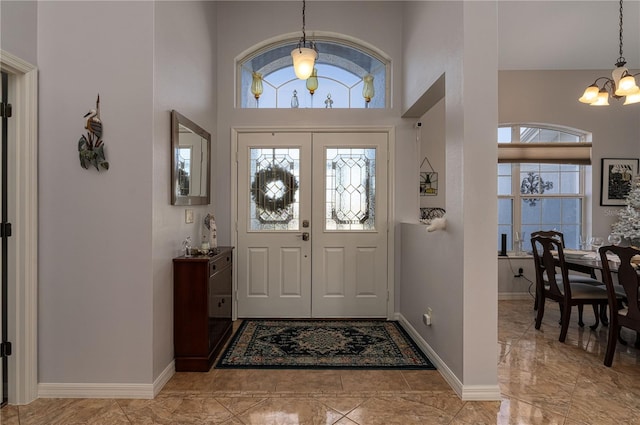 entryway featuring a high ceiling and a notable chandelier