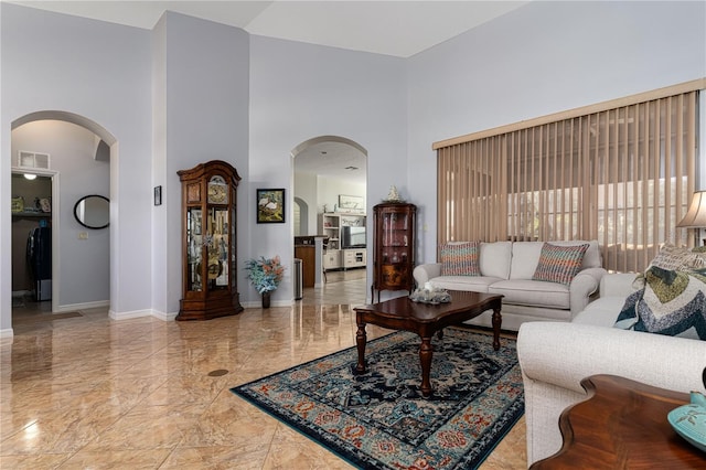 living room featuring a high ceiling