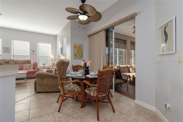 dining space featuring ceiling fan and light tile patterned flooring