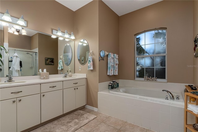 bathroom with tile patterned floors, vanity, and independent shower and bath