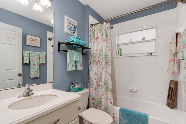 full bathroom featuring shower / bath combo with shower curtain, vanity, and toilet