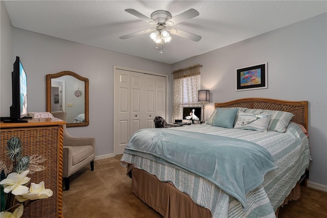 bedroom with a textured ceiling, carpet floors, a closet, and ceiling fan