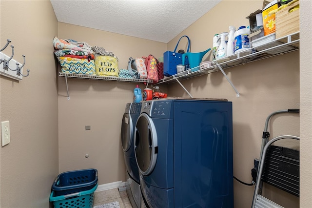 laundry area featuring tile patterned floors, a textured ceiling, and independent washer and dryer