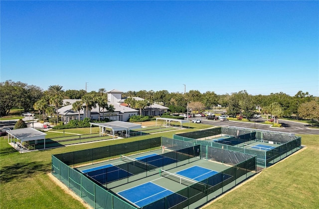 view of tennis court featuring a yard