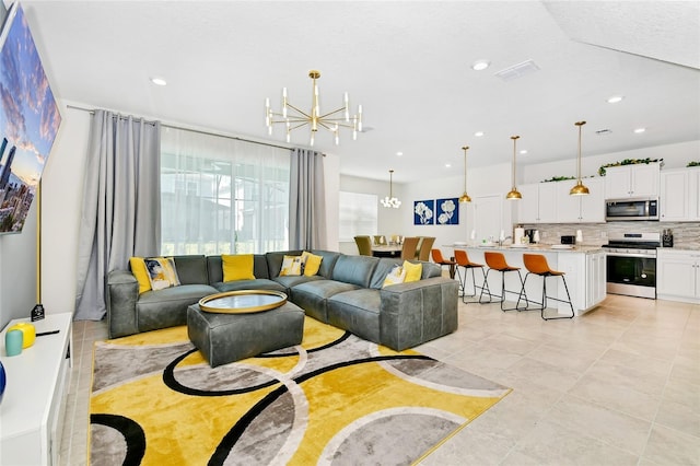 tiled living room featuring a notable chandelier