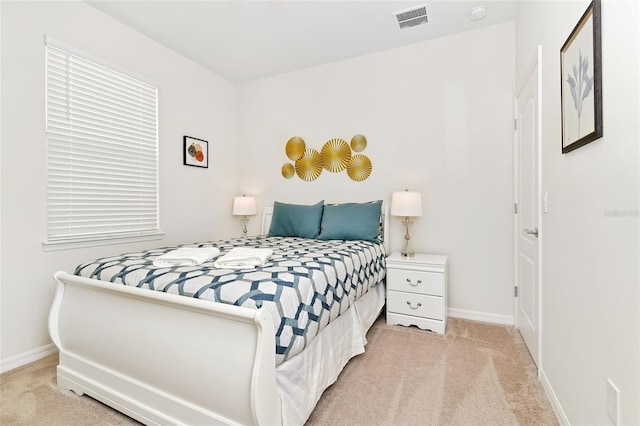 bedroom featuring light colored carpet