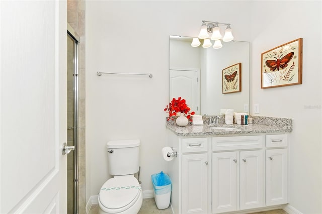 bathroom with vanity, toilet, and a shower with door