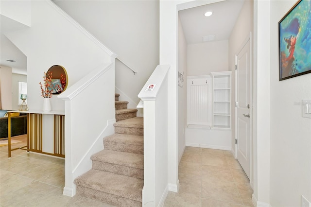 staircase featuring tile patterned flooring