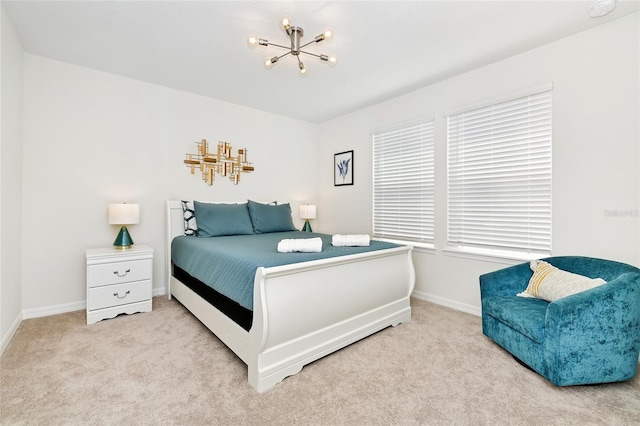 bedroom featuring light carpet and a chandelier