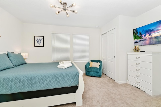 carpeted bedroom with a closet and a notable chandelier