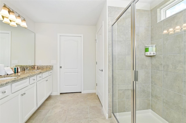 bathroom featuring vanity, tile patterned floors, and a shower with shower door