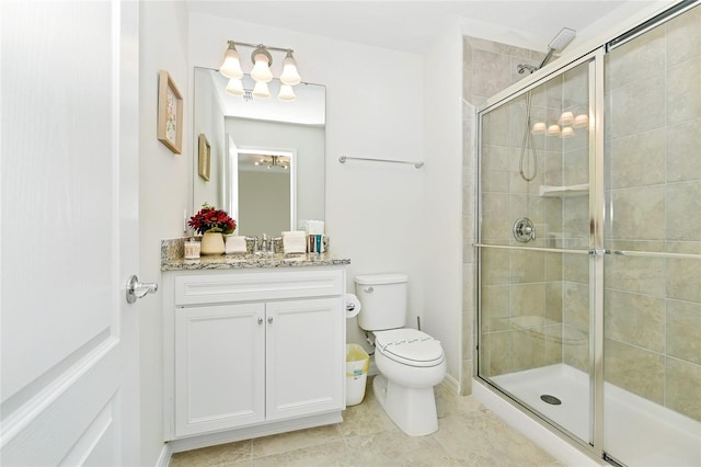 bathroom featuring tile patterned floors, vanity, toilet, and an enclosed shower