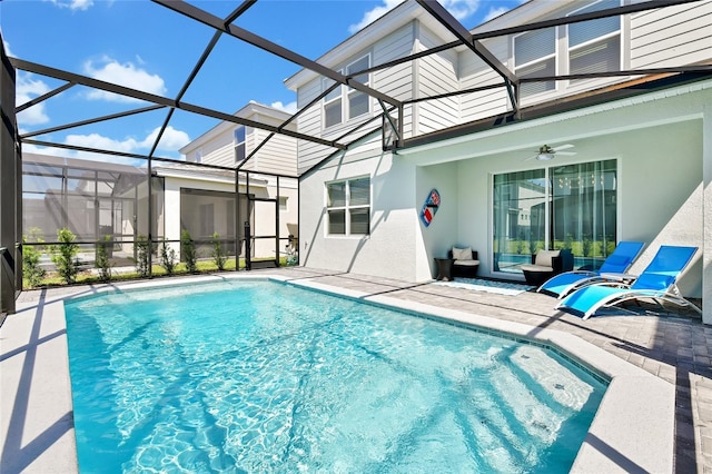 view of pool featuring ceiling fan, a lanai, and a patio