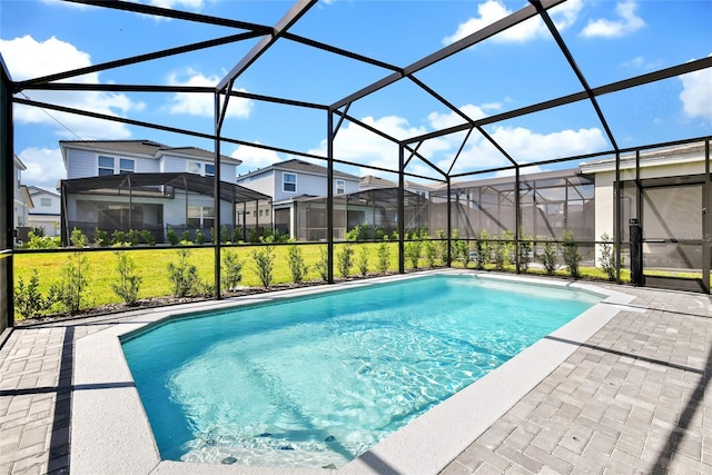 view of swimming pool with a patio and glass enclosure