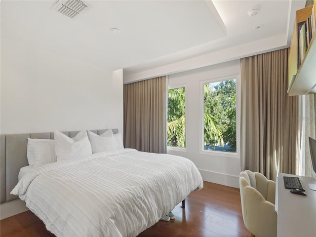 bedroom with dark wood-type flooring