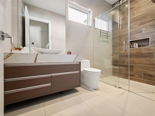 bathroom with tile patterned flooring, vanity, toilet, and walk in shower