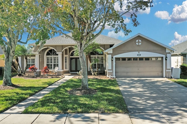 ranch-style house with a front yard and a garage