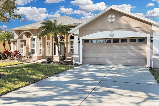 view of front of home with a garage and a front yard