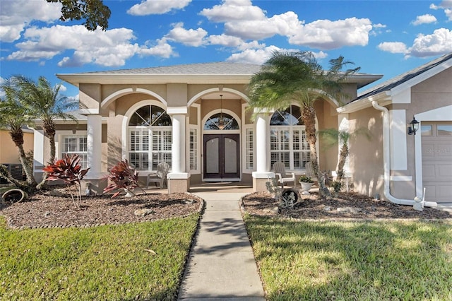 entrance to property with a lawn and central AC