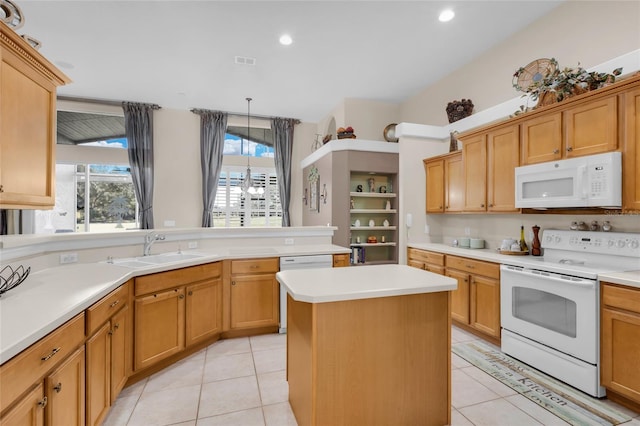 kitchen with white appliances, sink, light tile patterned floors, a center island, and hanging light fixtures