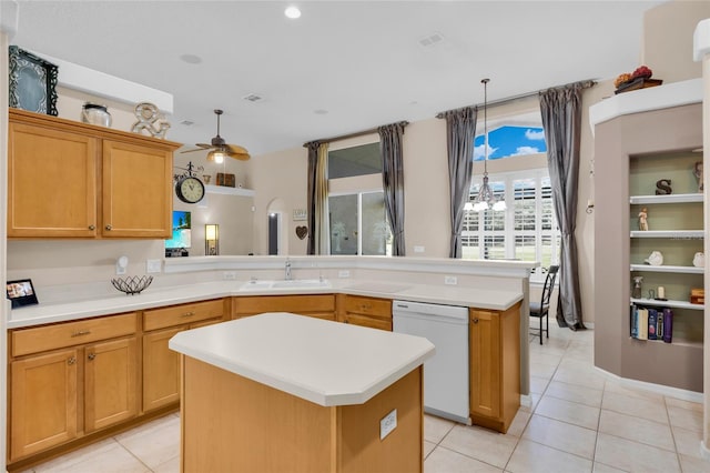 kitchen with a center island, sink, kitchen peninsula, white dishwasher, and pendant lighting