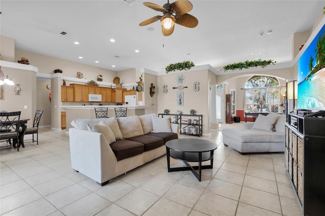 living room with ceiling fan with notable chandelier and light tile patterned floors