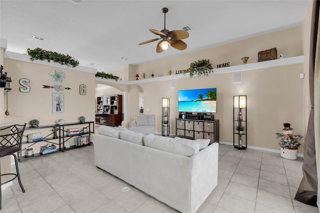 tiled living room featuring ceiling fan