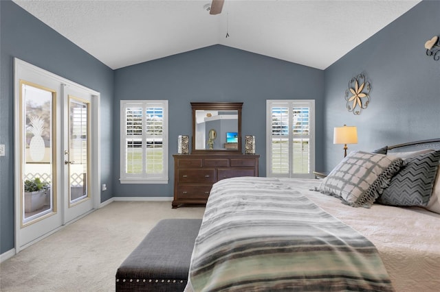 carpeted bedroom featuring multiple windows, ceiling fan, lofted ceiling, and access to exterior