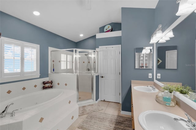 bathroom with plus walk in shower, vanity, vaulted ceiling, and tile patterned flooring