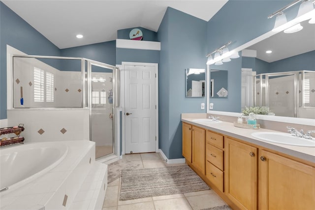 bathroom with vanity, independent shower and bath, and vaulted ceiling