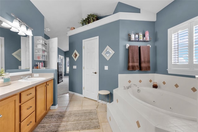 bathroom featuring tiled tub, tile patterned flooring, vanity, and vaulted ceiling