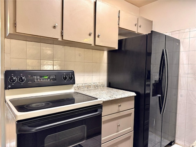 kitchen with black fridge with ice dispenser, tasteful backsplash, and white range with electric stovetop