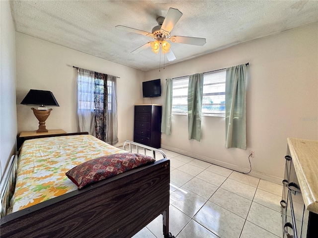 bedroom featuring light tile patterned floors, a textured ceiling, multiple windows, and ceiling fan