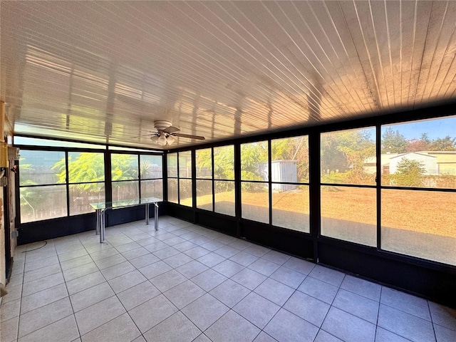 unfurnished sunroom featuring a wealth of natural light and ceiling fan