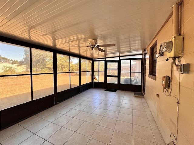 unfurnished sunroom featuring ceiling fan and vaulted ceiling