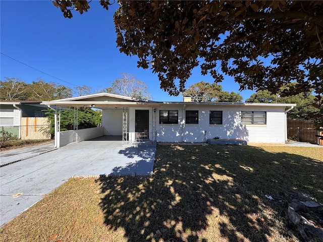 ranch-style house with a front lawn and a carport