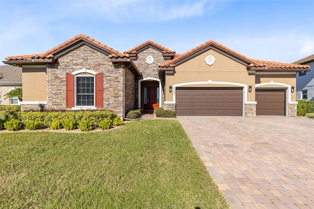 mediterranean / spanish-style house featuring a garage and a front lawn