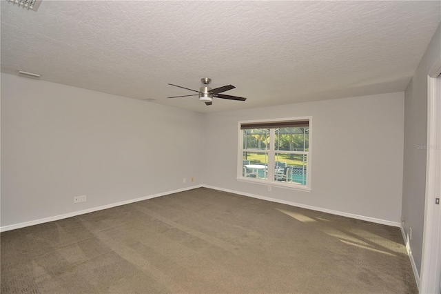 unfurnished room with a textured ceiling, ceiling fan, and dark colored carpet