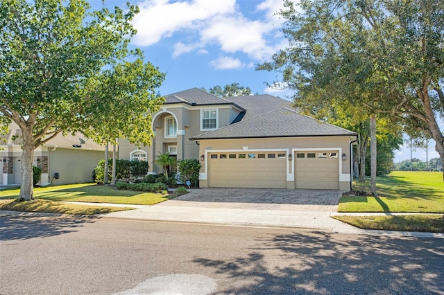 view of front facade featuring a front yard and a garage