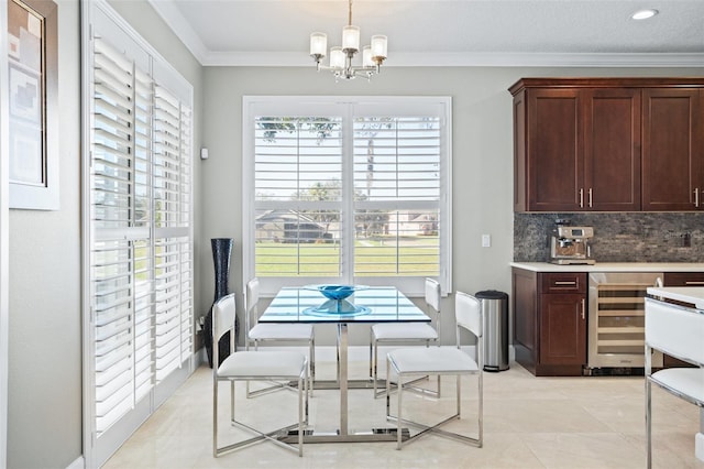 tiled dining area featuring a notable chandelier, ornamental molding, and wine cooler