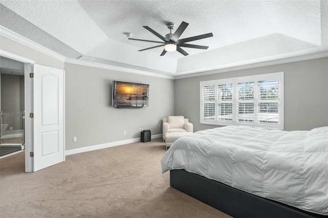 carpeted bedroom featuring a tray ceiling, ceiling fan, a textured ceiling, and ornamental molding