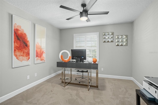 office area featuring light carpet, a textured ceiling, and ceiling fan