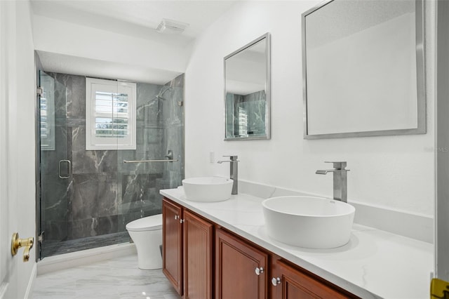 bathroom featuring vanity, toilet, and a shower with door