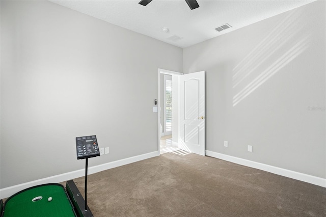 interior space with carpet and ceiling fan