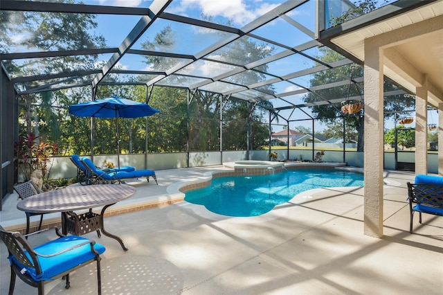 view of pool featuring a patio area, a lanai, and an in ground hot tub