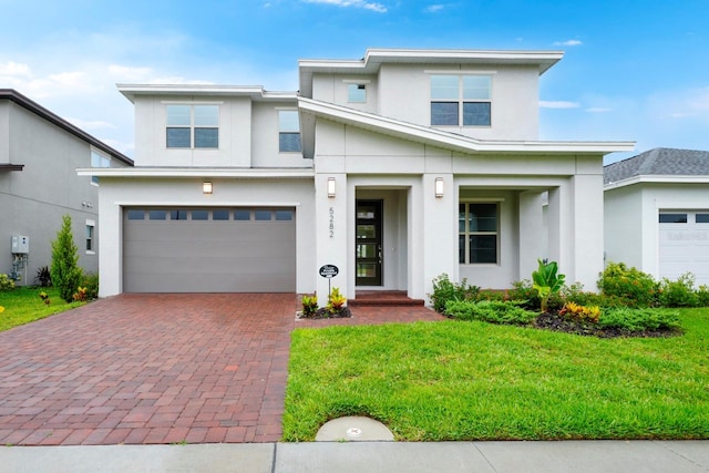 view of front of house with a garage and a front yard