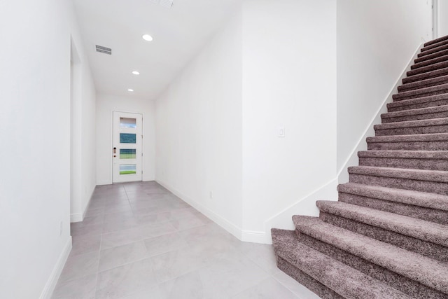 hall with light tile patterned floors