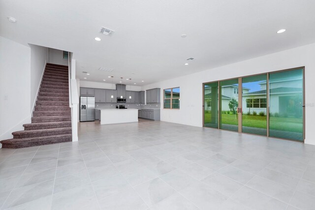 unfurnished living room featuring light tile patterned flooring